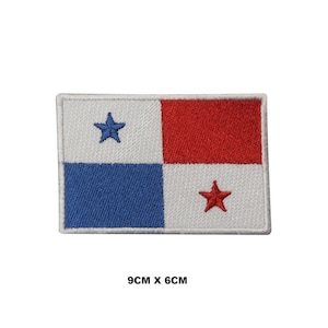 May include: An embroidered patch of the Panamanian flag. The flag is white with a blue square in the bottom left corner and a red rectangle in the top right corner. There are five-pointed stars in the centre of the blue and red sections. The patch is 9 cm by 6 cm.