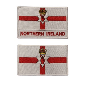 May include: Two rectangular embroidered patches displaying the Northern Ireland flag. The design features a red cross, a six-pointed star with a red hand, and a gold crown. One patch has the text "NORTHERN IRELAND" embroidered on it.