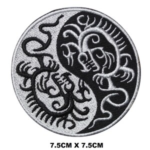 May include: Black and white embroidered patch featuring a yin yang symbol with a dragon design on each side. The patch is 7.5 cm in diameter.