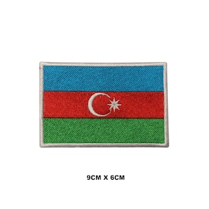 May include: Embroidered patch of the Azerbaijani flag. The flag is blue, red, and green with a white crescent moon and star in the center. The patch is 9 cm by 6 cm.