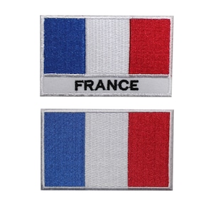 Könnte beinhalten: Zwei gestickte Aufnäher mit der französischen Flagge. Der obere Aufnäher hat das Wort "FRANCE" unter der Flagge. Beide Aufnäher haben einen weißen Hintergrund mit einem grauen Rand.