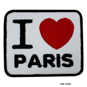 May include: White iron-on patch with black embroidery that says "I love Paris" with a red heart in the middle. The patch is 7 cm by 6 cm.