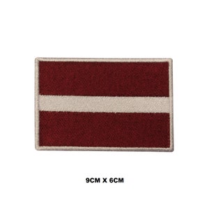 May include: A red and white embroidered patch of the Latvian flag. The patch is 9 cm by 6 cm.