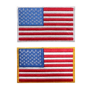 May include: Two embroidered American flag patches. The top patch is red, white and blue with a white border. The bottom patch is red, white and blue with a gold border.