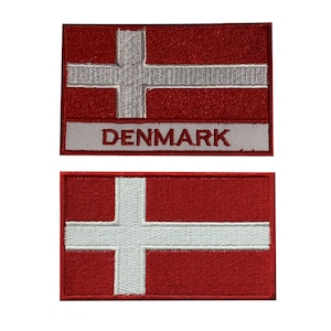 May include: Two embroidered patches featuring the Danish flag. The top patch has the flag with the word "DENMARK" below it. The bottom patch is just the flag.
