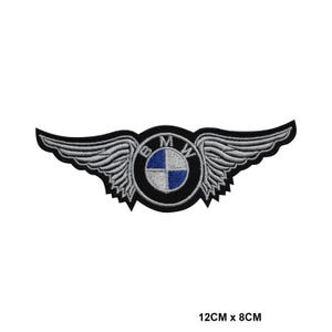 May include: Embroidered patch with the BMW logo and wings. The patch is black, white, and blue, with the text "BMW" and measures 12cm wide by 8cm high.