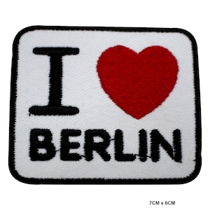 May include: White embroidered patch with the text "I love Berlin" in black lettering and a red heart.