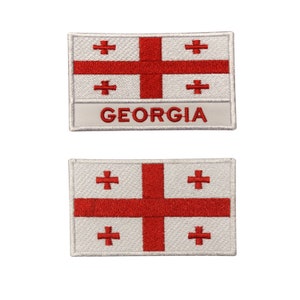 May include: Two embroidered patches featuring the flag of Georgia. The top patch has the flag with the word "GEORGIA" below it. The bottom patch is just the flag.