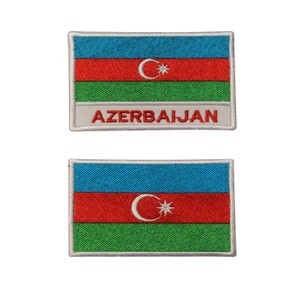 May include: Two embroidered patches featuring the flag of Azerbaijan. The top patch has the words "AZERBAIJAN" printed below the flag. Both patches have a white border.