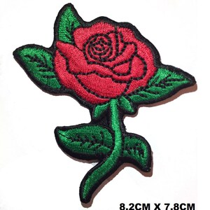 May include: Red embroidered rose patch with green leaves and stem. The patch measures 8.2 cm by 7.8 cm.