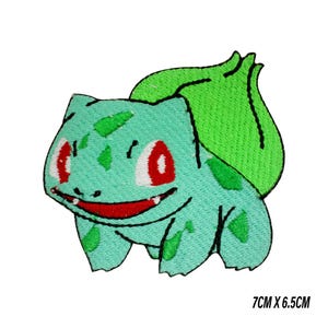 May include: Embroidered patch of a Bulbasaur character in green, with red eyes and a smiling mouth. The patch measures 7cm x 6.5cm. Ideal for customising clothing or accessories.