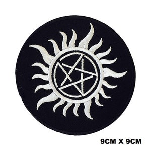 May include: White embroidered patch with a pentagram inside a circle of flames on a black background. The patch is 9 cm by 9 cm.