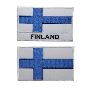 May include: Two embroidered patches featuring the Finnish flag. The top patch has the flag design with the word "FINLAND" below it. The bottom patch shows the flag design only.