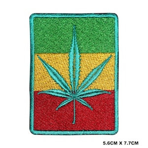 May include: Green, yellow, and red embroidered patch with a teal marijuana leaf in the center. The patch measures 5.6 cm by 7.7 cm.