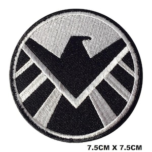 May include: A circular embroidered patch featuring a black and white eagle emblem design. The patch has a black border and measures 2.95 inches by 2.95 inches. The central graphic depicts a stylized eagle silhouette in white against a black background.