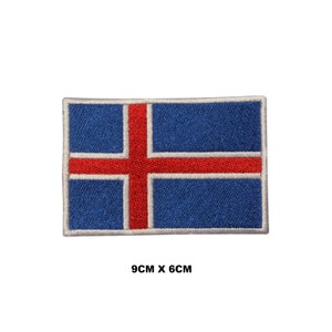 May include: Embroidered Icelandic flag patch with a blue background and a white cross with a red center. The patch measures 9 inches by 6 inches.