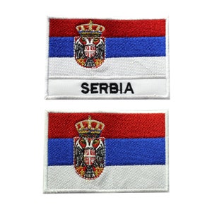 May include: Two embroidered patches featuring the flag of Serbia. The top patch has the word "SERBIA" written below the flag.