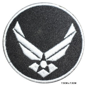 May include: A black and white embroidered patch featuring the United States Air Force logo. The patch is circular and measures 7.5 cm in diameter.