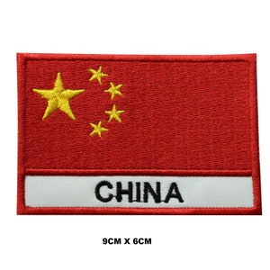 May include: Embroidered patch of the Chinese flag with five yellow stars on a red background. The patch has a white border and the word "CHINA" written in black below the flag. The patch measures 9 cm by 6 cm.