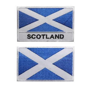 May include: Two embroidered patches featuring the Scottish flag, a blue background with a white diagonal cross. The top patch has the word "SCOTLAND" written in black below the flag.