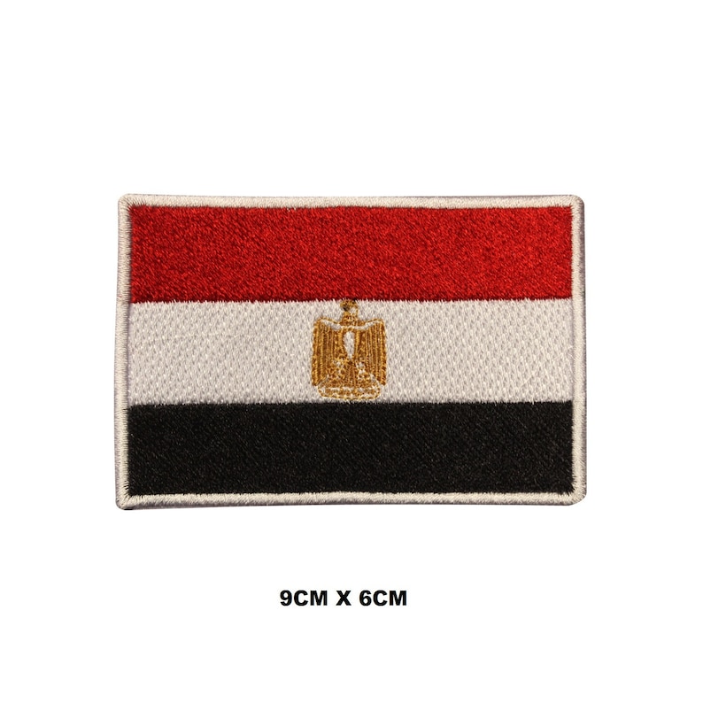 May include: An embroidered patch of the Egyptian flag. The flag is red, white, and black with a gold eagle in the center. The patch is 9 cm by 6 cm.