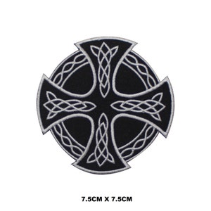 May include: A black and silver embroidered iron-on patch featuring a Celtic cross design. The cross is surrounded by a circle of intricate knotwork. The patch measures 7.5 inches by 7.5 inches.