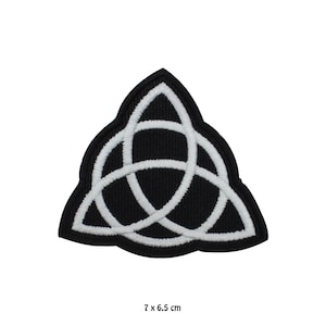 May include: Embroidered black and white patch with a Celtic knot design. The patch has a triangular shape, with a black base and a white, interwoven knot. The patch measures 7 x 6.5 cm.