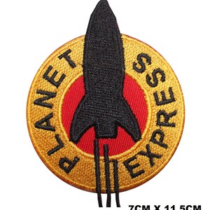 May include: A circular embroidered patch featuring a black rocket ship silhouette centered over a red circle, surrounded by a gold border with the black text PLANET EXPRESS. The patch measures 7cm x 11.5cm as indicated by the text below it.