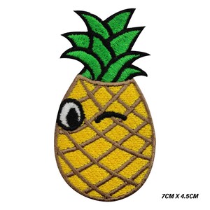 May include: Embroidered pineapple patch with a winking face. The patch features a yellow body with brown grid lines, green leaves, and a black and white eye. The patch measures 7cm x 4.5cm.