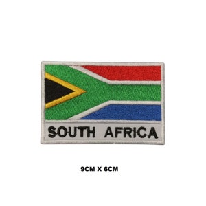 May include: An embroidered iron-on patch featuring the South African flag with the words "SOUTH AFRICA" below. The patch is 9 cm by 6 cm.