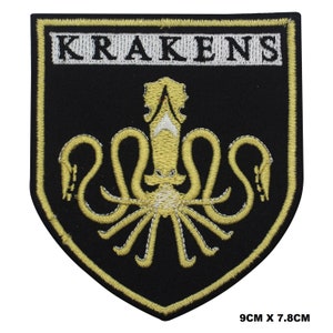 May include: A black and gold embroidered patch with the word "KRAKENS" in white lettering. The patch features a gold embroidered kraken with eight tentacles.