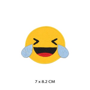 May include: Yellow embroidered iron-on patch of a laughing emoji with tears of joy. The patch is 7 by 8.2 centimetres.