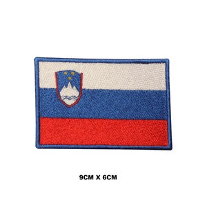 May include: Embroidered patch of the Slovenian flag. The flag is white, blue, and red with the Slovenian coat of arms in the top left corner. The patch measures 9cm by 6cm.