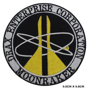 May include: An embroidered patch in black and yellow with the text "Drax Enterprise Corporation Moonraker" in a white circle.