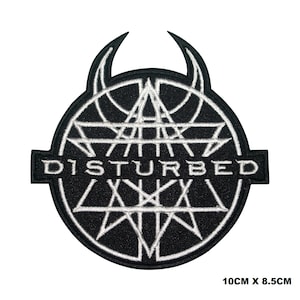 May include: Black and white embroidered patch with the band name "DISTURBED" in a white circle with a white star and a white triangle design. The patch is 10cm x 8.5cm.