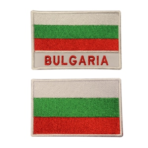 May include: Two rectangular patches displaying the Bulgarian flag. Each patch has a white top stripe, a green central stripe, and a red lower stripe. The top patch features the word "BULGARIA" embroidered in red.