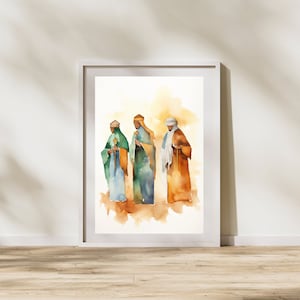 Könnte beinhalten: Gerahmtes Aquarellgemälde, das drei Figuren in Gewändern zeigt, jede mit einem Stab. Die Figuren sind in Grün-, Blau- und Brauntönen gehalten, vor einem warmen, abstrakten Hintergrund. Der Rahmen ist weiß.