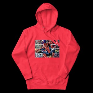 May include: A red hoodie with a Spider-Man comic book panel design on the front. The graphic is a collage of comic book panels. The hoodie has a kangaroo pocket and a drawstring hood. The background is black.