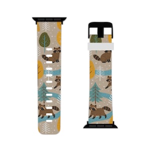 May include: Watch band featuring a repeating pattern of raccoons, trees, and a blue river on a tan background. The design includes yellow and green trees, and the raccoons are brown with black stripes on their tails.