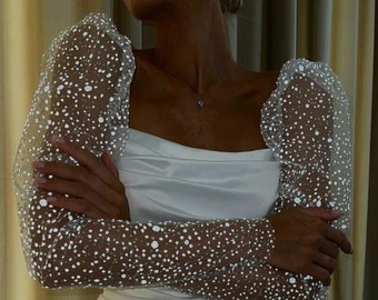 Le maniche da sposa rimovibili in tulle scintillante per abito da sposa hanno l'aspetto di maniche a sbuffo con un elastico.