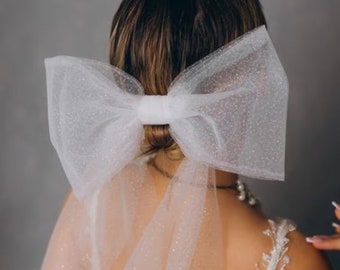 Sparkly  veil bow  for the bride on a hairpin for a secure location in the hair.