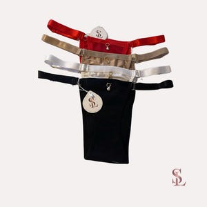 May include: Four pairs of black, red, beige, and white lingerie with adjustable straps and a gold charm. The lingerie has a tag with the letter "S" and a stylized "L" on it.