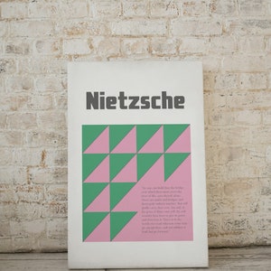 May include: A white poster with a quote by Friedrich Nietzsche. The poster features a geometric pattern of pink and green triangles. The quote reads: "No one can build you the bridge over which you must cross the river of life, save yourself alone. There are paths and bridges and guides and gods, but you must find your own way without number, and the price of love, and the cost of the journey, and the price of the victory, must be borne by yourself alone. There is no path, except that which you make yourself, and no law, except that which you lay down for yourself."