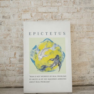 May include: A white canvas print with a quote by Epictetus, a Greek philosopher, about real problems and imagined anxieties. The quote is printed in black text and is accompanied by a watercolor painting of two fish swimming in a blue and yellow circle.