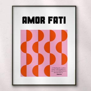 May include: A black framed poster with the text "AMOR FATI" in bold white letters. The background is pink with a repeating pattern of orange semi-circles. A quote by Aurelius is printed at the bottom of the poster: "A blazing fire makes flame and brightness out of everything that is thrown into it."