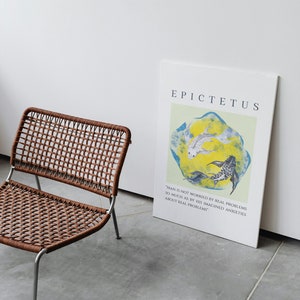 May include: A white poster with the text "EPICTETUS" and a quote by Epictetus: "Man is not worried by real problems so much as by his imagined anxieties about real problems". The poster features a watercolor painting of two fish swimming in a yellow and blue circle.