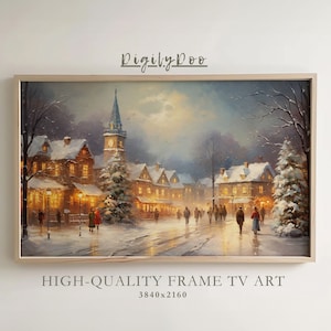 May include: A framed painting of a snowy village scene at night. The village is lit up with warm, yellow lights, and there are people walking around. There is a tall church steeple in the background, and a full moon in the sky. The painting is in a light wood frame.