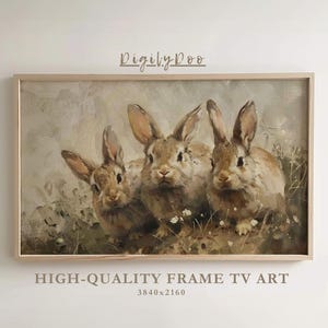 May include: A framed painting of three brown rabbits in a field of flowers. The rabbits are looking at the viewer. The painting is in a light wood frame.