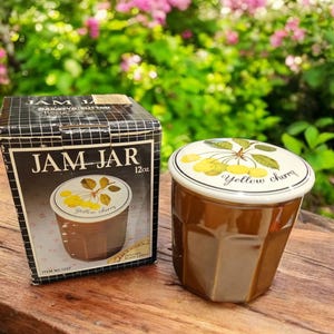 May include: A brown ceramic jam jar with a white lid featuring a yellow cherry design. The lid has the text "yellow cherry" printed on it. The jar is 12 ounces and comes in a box with the text "JAM JAR" printed on it.