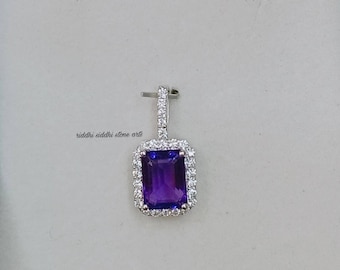 May include: A silver pendant with a large, rectangular, purple amethyst gemstone surrounded by a halo of smaller, white diamonds.